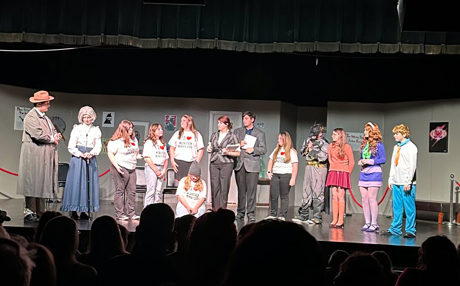 Student cast members stand on stage during a Grant Junior High Theatre Program production.