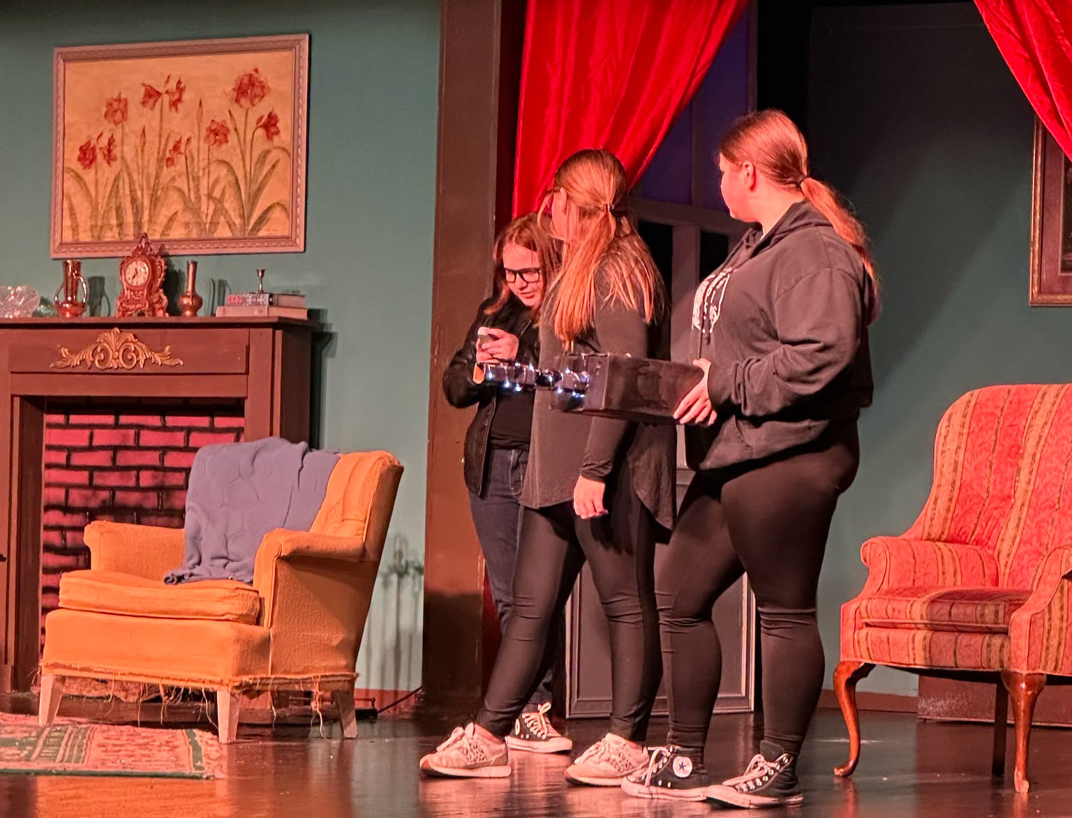 Students work together on stage during a theatre production.