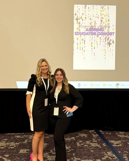 Two Grant Parish educators stand together in front of a Learning Library Educator Cohort presentation screen.