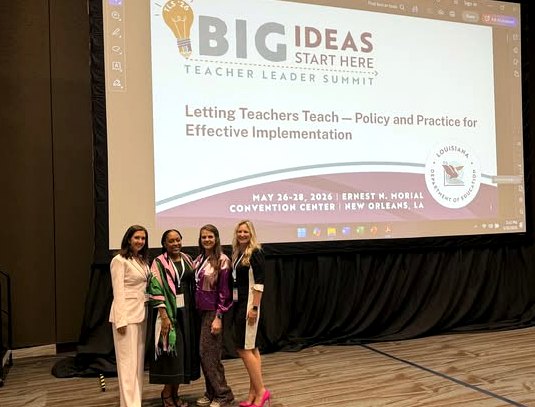 Grant Parish educators stand in front of a Teacher Leader Summit presentation screen for a session on effective implementation.
